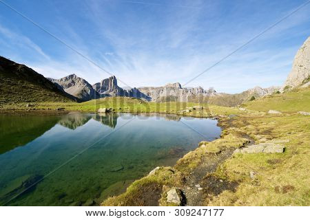 Peaks reflected in Ansabere Lake. Lescun Cirque. Aspe Valley, Pyrenees, France.
