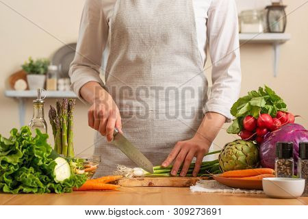 The Chef Cuts Green Onions, On A Light Background. The Concept Of Losing Healthy And Healthy Food, D