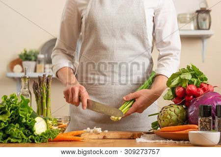 The Chef Cuts Green Onions, On A Light Background. The Concept Of Losing Healthy And Healthy Food, D