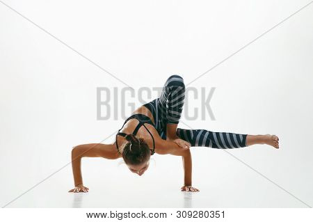 Sporty Young Woman Doing Yoga Practice Isolated On White Studio Background. Fit Flexible Female Mode