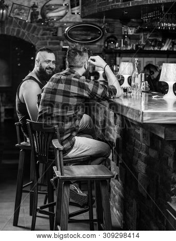 Friendship And Leisure. Friends Relaxing In Pub. Order Drinks At Bar Counter. Hipster Brutal Bearded