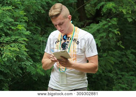 Brusilov, Ukraine - July 17, 2017: A Sports Guy In A White T-shirt Is Recording The Results Of The T