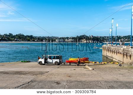 Morgat, France - August 4, 2018:  People Taking Out The Water And Storing Canoes And Kayaks In The M
