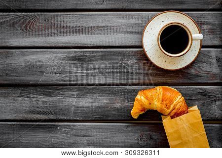 Breakfast With Croissant In Paper Bag And Cup Of Coffee On Wooden Background Top View Mock Up