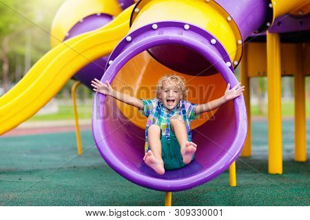 Child On Playground. Kids Play Outdoor.