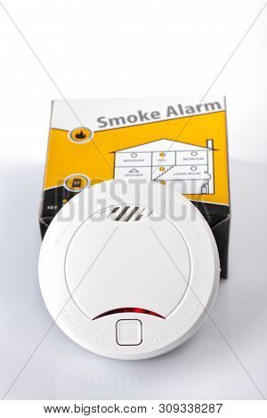 A Smoke Alarm With Its Box Isolated On White Background