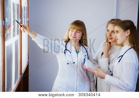 Group Of Nurse Studying The Sections Of The Brain. The Concept Of Health Education. Students In The 
