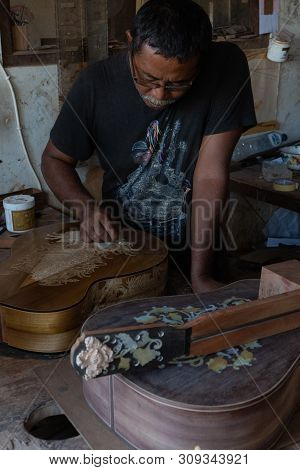 Gianyar,bali/indonesia-may 30 2019: A Guitar Craftsman Are Carving A Classical Guitars Made From Woo
