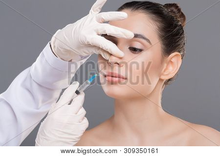 Plastic Surgery Of Nose. Doctor Filling Injection Into Female Nose, Alternative Rhinoplasty