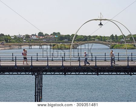 Southport, Merseyside, United Kingdom - 28 June 2019: People On The Historic Pier In Southport Merse