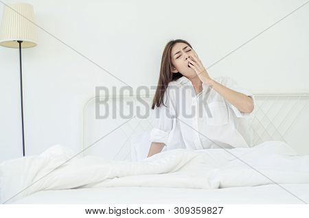 Women Sit At The Edge Of The Bed.
