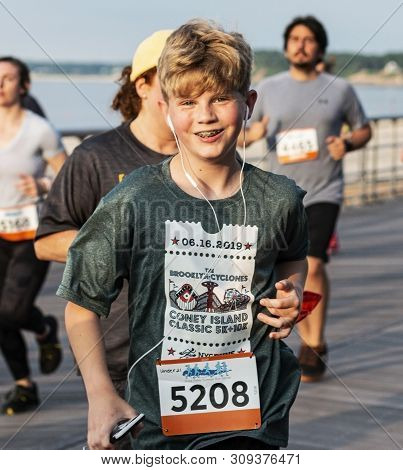 Kings Park, New York, Usa - 17 June 2019: Young Runner On The Boardwalk Smiling At The Camera During