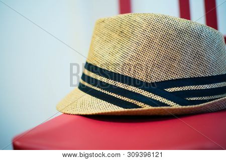 Brown Derby Cap Hang On Red Chair