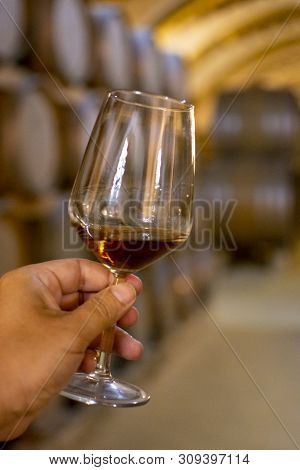 Tasting Of Fortified Dry Or Sweet Marsala Wine In Vintage Wine Cellar With Old Oak Barrels In Marsal