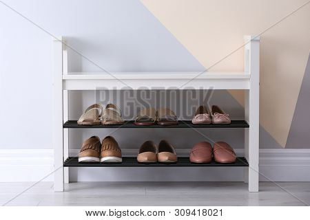 Shoe Rack With Different Footwear Near Color Wall, Space For Text. Stylish Hallway Interior