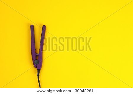 Modern Hair Iron For Straightening On Color Background, Top View With Space For Text