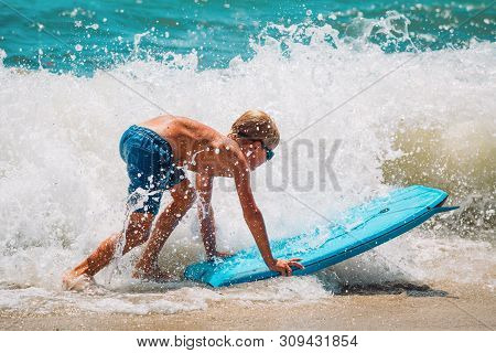 Happy Boy Enjoy Surfing At Sea, Kids Play With Water On Vacaton