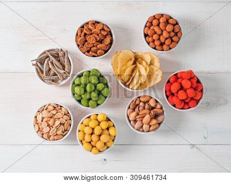 Assortment Of Different Snack For Beer, Wine, Party. Peanuts In Coconut Glaze, Green Vasabi, Red Spi