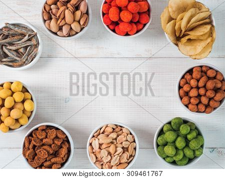 Assortment Of Different Snack For Beer, Wine, Party. Peanuts In Coconut Glaze, Green Vasabi, Red Spi