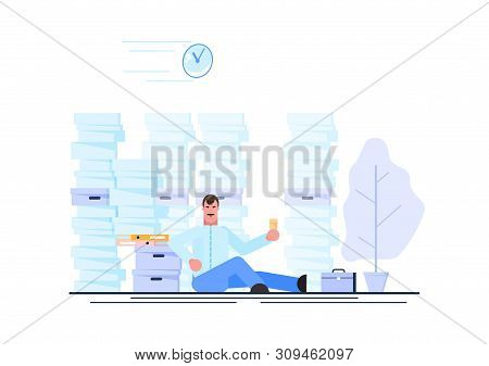 Business Man Is Resting At His Workplace Desk During Working Hours With The Piles Of Paper Document