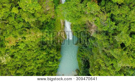 Waterfall In The Rainforest Jungle From Above. Tropical Mantayupan Falls In Mountain Jungle. Philipp