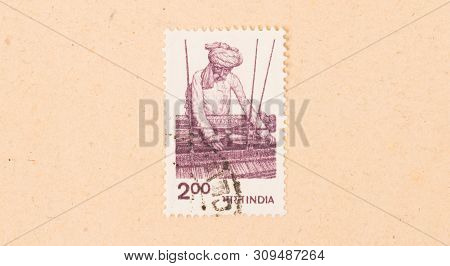 India - Circa 1970: A Stamp Printed In India Shows A Man Working A Loom, Circa 1970