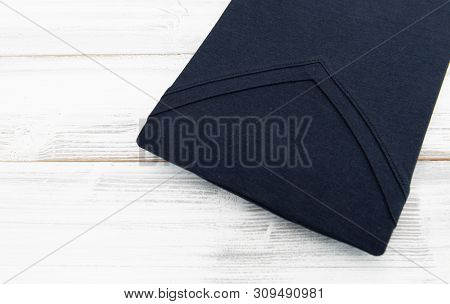New Black V Neck Shirt On White Wooden Background