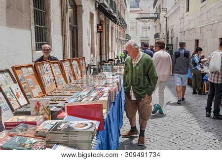 Lisbon, Portugal: Customers Of Popular Outdoor Flea Market Looking For Rare Books At Weekend On 18 M