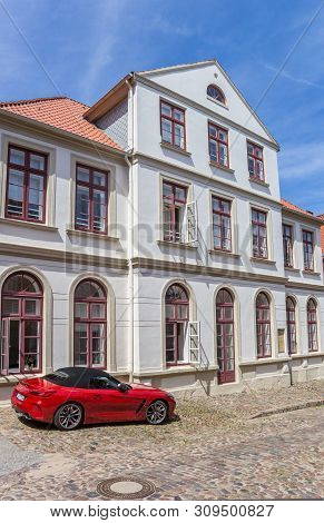 Plon, Germany - June 24, 2019: Red Car In Front Of A Historic Building In Plon, Germany