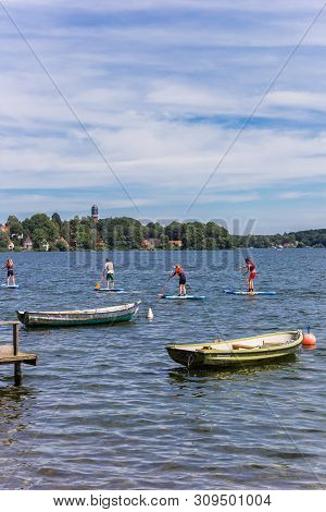 Plon, Germany - June 24, 2019: People Doing Standup Paddleboarding In The Lake Of Plon, Germany