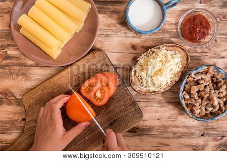 Italian Food Concept. Ingredients For Cooking Pasta. Dry Cannelloni Pasta, Cherry Tomatoes, Fresh Ba