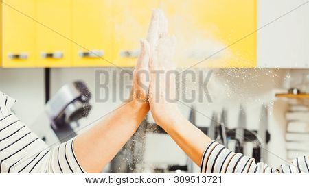 Successful Culinary Cooperation. Closeup Of Women Hands Giving High Five, Shacking Off Flour.