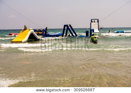 Mil Palmeras, Costa Blanca, Spain - July 02 2019: People On Beach Enjoying The Sun And Playing On In