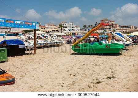 Mil Palmeras, Costa Blanca, Spain - July 02 2019: People On Beach Enjoying The Sun And Playing On In