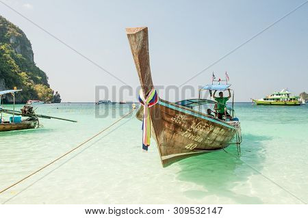 Thailand, Phi Phi Island, 3 February 2018: Front Of The Long Tail Boat With Drivers. Traditional Lon