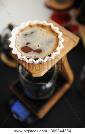 Brewing Coffee In Pink Ceramic Origami Dripper. Top View. On Wooden Coffee Stand. Close Up. Alternat