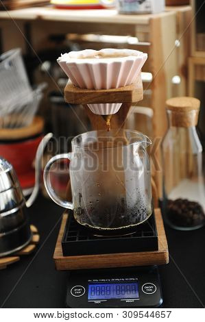 Brewing Coffee In Pink Ceramic Origami Dripper On Wooden Stand. Alternative Manual Brew. Electronic 