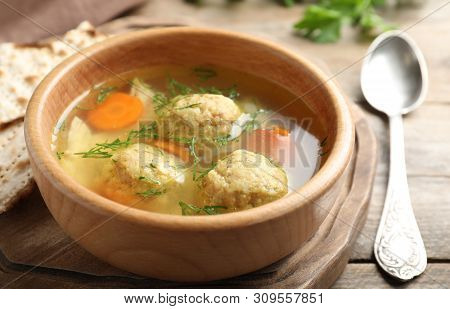 Bowl Of Jewish Matzoh Balls Soup On Wooden Table, Closeup