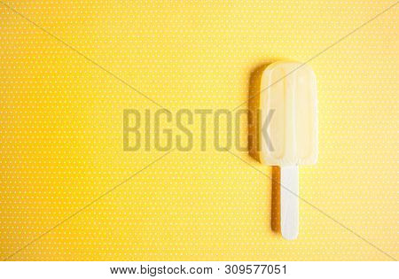 Ice Cream Shaped Lollipop On Yellow White Polka Dod Background.