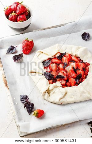 Homemade Strawberry Open Cake Of Gallet With Purple Basil And Balsamic Sauce Before Baking On A Ligh