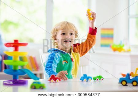 Boy Playing Toy Cars. Kid With Toys. Child And Car