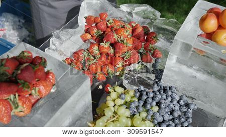 Assorted Fruit From Grape Pear Strawberry Apricot Peaches Blueberries On Ice. The Concept Of Healthy