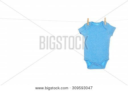Baby Onesie Hanging On Clothes Line Against White Background. Laundry Day