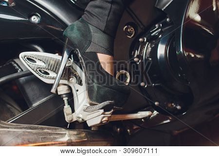 Female Foot In Slippers On A Motorcycle Kickstart.