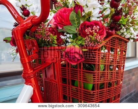 Bicycle Handlebar And Basket With Flowers. Beautiful Artificial Flowers In The Bike Basket. Stylish 