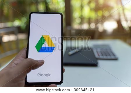Chiang Mai, Thailand - May.26,2019: Man Hands Holding Xiaomi Mi Mix 3 With Google Drive Apps On Scre