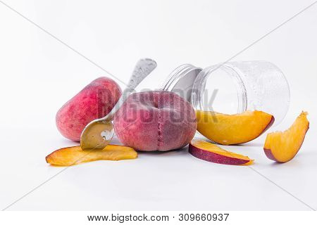 Red And Ripe Flat Peaches - Fresh Slices Of Sweet Flat Peach With A Glass Glass On A White Backgroun