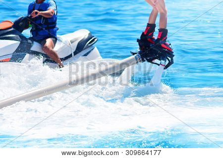 Flyboarding And Seariding In A Blue Sea