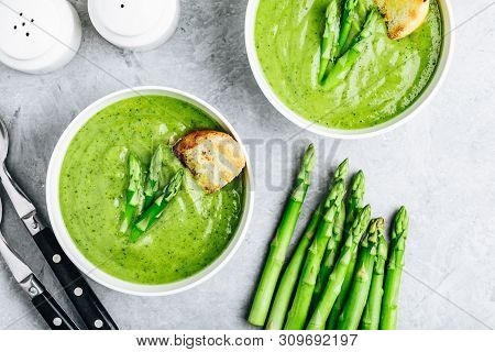 Asparagus Cream Soup With Croutons On Gray Stone Background.