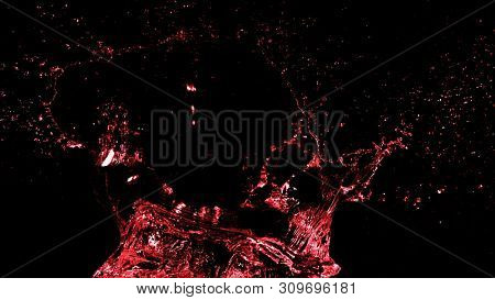 Abstract red wine splash shape on black background. Bavaragers and drink graphic element